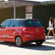 Some people walking away from a Fiat 500L, like everyone does